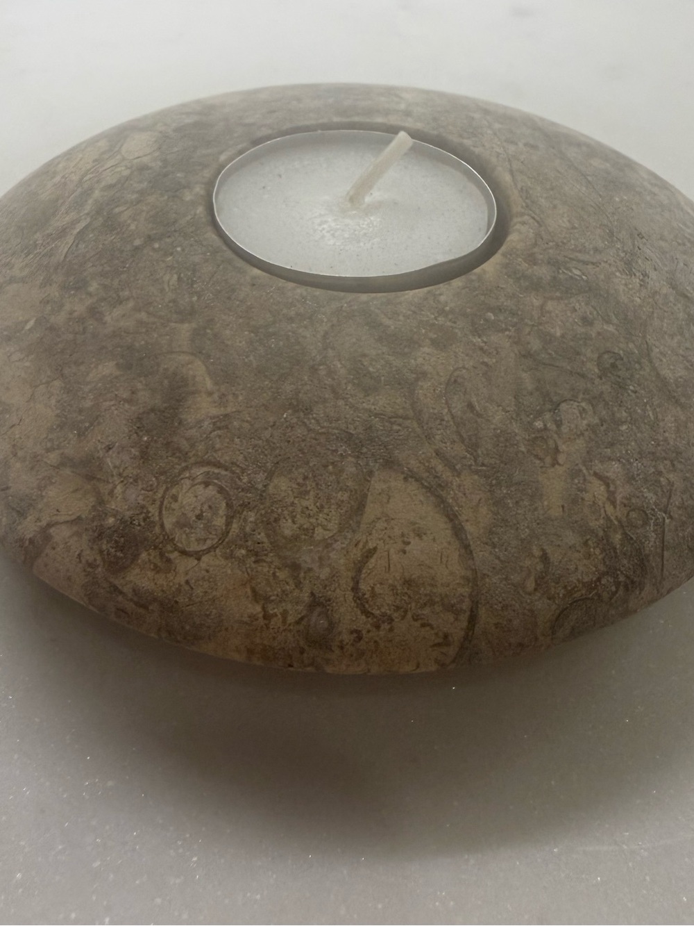 Flat Chinese circular natural stone replica with a tea light hole at center